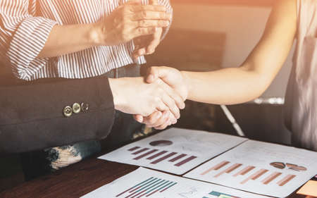 Group asia businessman woman together create a mutually beneficial business relationship. Economic graph on the tableの写真素材