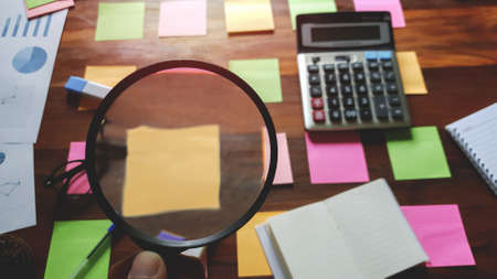 Glasses and Notes paper supplies on desktop wood table. Brainstorming Brainstorm conceptの写真素材