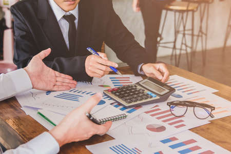 Start up business. people team work meeting point to discuss the graph up and down of economy and work on tablet.Selective Focusの写真素材