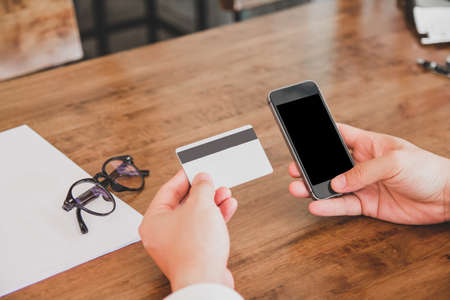 Businessman in white shirt using credit card  shopping  of Men's wear online on digital mobile phoneの写真素材