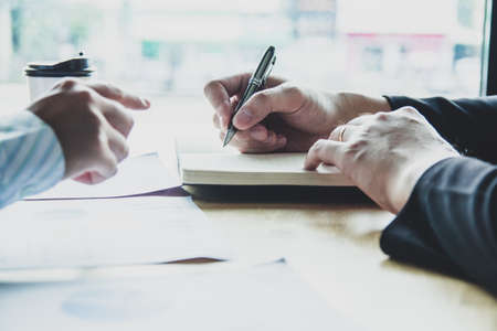 Asian young man and woman sitting pointing studying examining. Tutor books with friends. Young...
