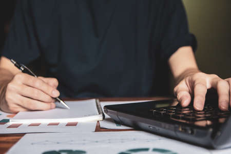 Asian young business man of student holding a pen writing letter on paper at home