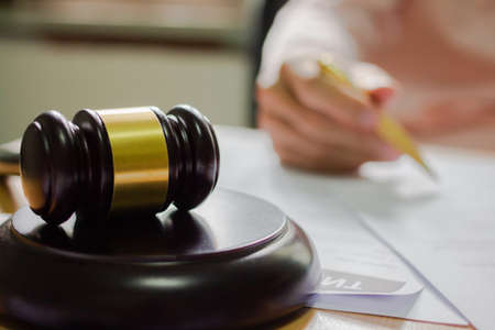 businessman or lawyers sitting office signing contract papers on wood table. Law of advisor Concepts and vintage, Sunset light.Selective Focusの写真素材