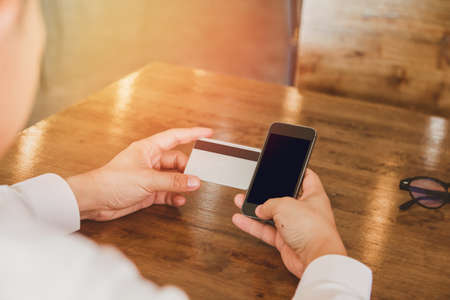 Businessman in white shirt using credit card  shopping  of Men's wear online on digital mobile phoneの写真素材