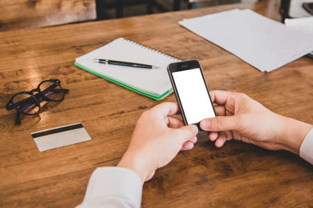 Businessman in white shirt using credit card shopping of Men's wear online on digital mobile phone