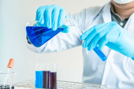 Close up. Medical or science medical in laboratory room research performs tests with liquid,...