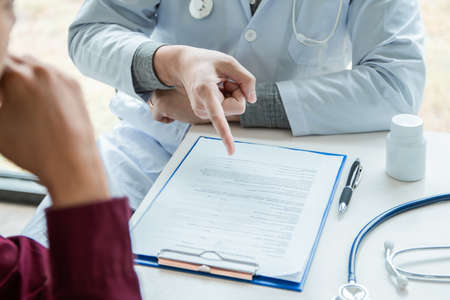 Doctor talking And patient counseling Should take care of yourself when the pain.の写真素材