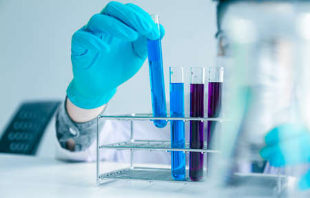 Medical science or male in laboratory room researcher performs tests with blue liquid on test tube , Experimental Drug Treatment Chemicalsの写真素材