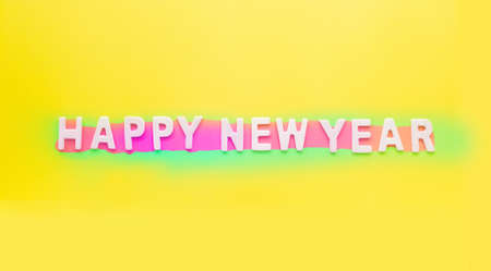 Sign and Symbol text of wooden Happy new Year  on bright yellow paper background.の写真素材