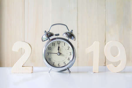 2019 Happy New Year with clock on white table background,Vintage tone,Copy space for your text.