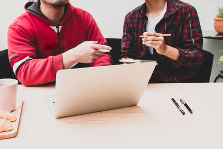 Two asian student Tutorial e-learning  online on digital laptop and exam at home.