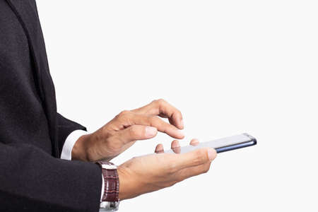 Business man in black suit using and touch screen display on technology smartphone isolated white...