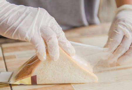 The process of sandwich package with shredded pork and jam. Put a plastic bag to send sales.の写真素材