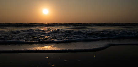 Beach sunset and incredible foamy waves in evening. Summer  holiday and vacation