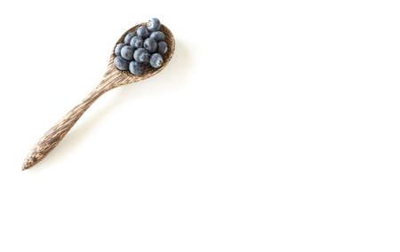 Fresh Blueberries in wooden spoon on white table backgroundの写真素材