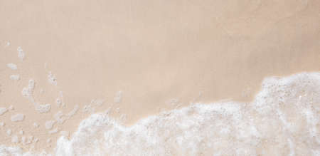 white ocean wave on sandy beach in summer vacation copy space for your textの写真素材