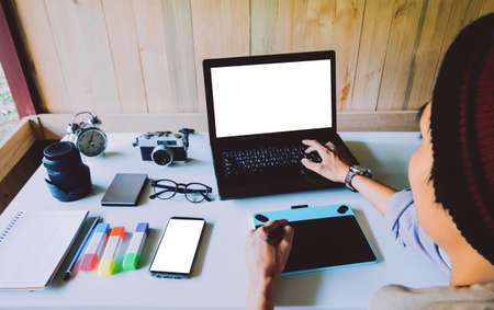 Asian man Interior designer of graphic design drawing on tablet and working laptop blank screen as...