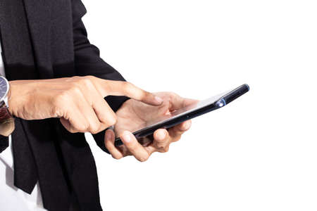 Business man in black suit using and touch screen display on technology smartphone isolated white...