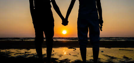 Asian of couple Lesbian romantic clap hand on the beach Sunset background Summer honeymoon vacation...