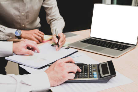 Group businessman hand using calculator Calculating bonus(Or other compensation) to employees to...