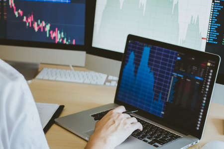 businessman working and looking directions change Average line Share price movement Stock trading in...