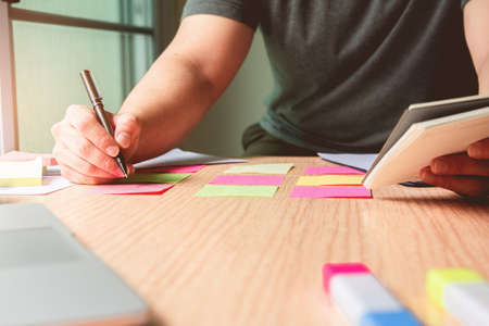 New. Business man holding pen meeting at home office and using notes paper share design planning ,brainstorming brainstorm idea on desktopの写真素材
