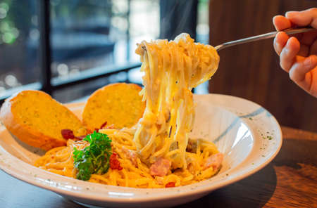 Spaghetti Carbonara with bacon and cheese at cafeの写真素材