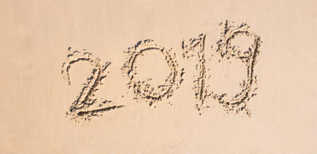 Happy New year 2019 Written on sand white on the  beach Travel and vacations Celebration Shoot photo by smart phoneの写真素材