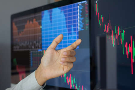 Hand of businessman pointing and look directions change Average line Share price movement Stock...