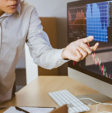 Hand of businessman pointing and look directions change Average line Share price movement Stock...