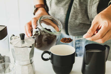 Asian man make a cup of coffee on table at homeの写真素材