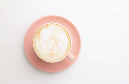 Hot coffee of cup trendy color of the year 2019 living coral. On wooden backgroundの写真素材