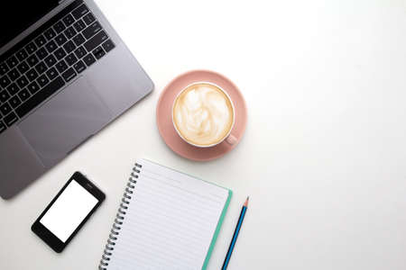 Desk top laptop computer ,Mobile phone blank white mockup,Coffee cup, Pen and note paper on white...