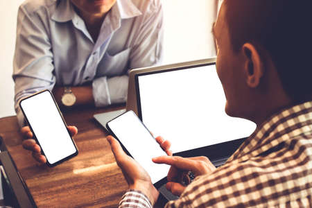 Newsletter concept Hand of group  businessman checking message box on digital mobile phone with laptop on tableの写真素材