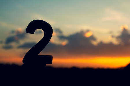 Number two sign symbol of wooden 2 text on evening nature sunset ,beautiful cloud