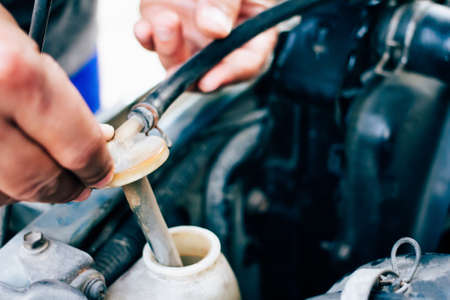 Mechanic maintenance small business service Man checking the radiator car.の写真素材