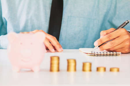 businessman Writing paper and using calculator Calculating bonus(Or other compensation) to employees...