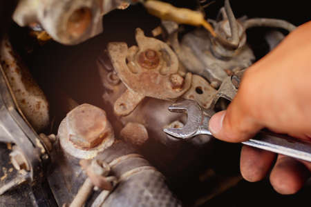 Mechanic maintenance small business service Man holding wrench  concept repair the car.  retro style filter photo vintage toneの写真素材