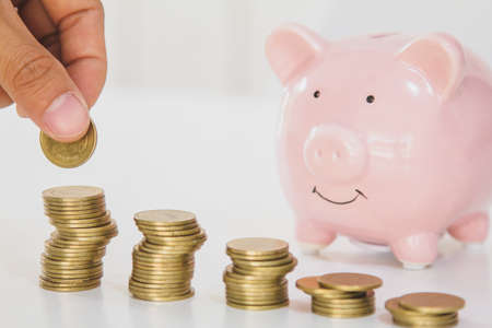 Handles coins placed on Saving money on the table. business finance concept.の写真素材