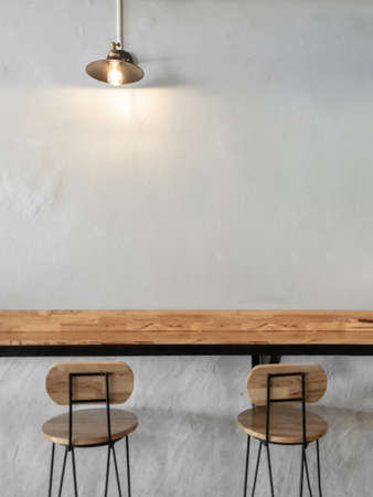 Empty on people. Coffee shop interior design With chairs, vintage light bulb and white walls.の写真素材