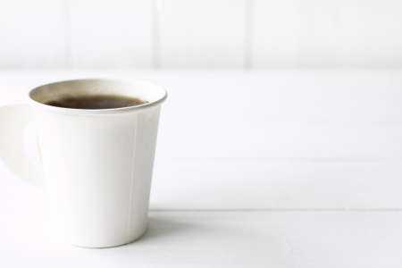 coffee in white paper cup on wood table, Package material Recycling concept.の写真素材