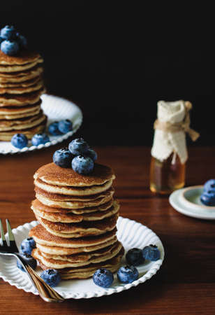 Blueberry Homemade pancake with sweet honey and fork silverware on wood table. Vertical photosの写真素材