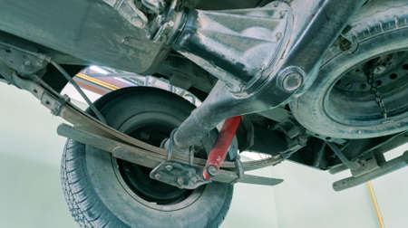 Car lifted in Manual pickup truck at service centre for fixing repairs change engine oilの写真素材