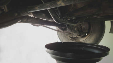 Mechanic fixing oil change at service  center. repair car concept