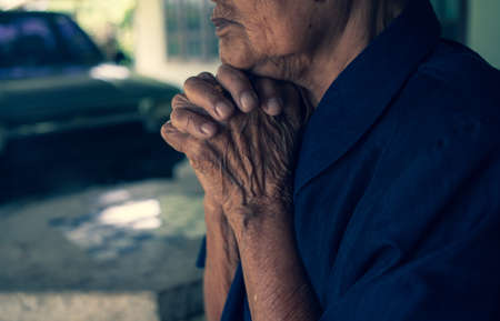 Praying hands of  Buddhism. Elderly woman god for  religion, belief, Holding hand in pray and thank buddhaの写真素材
