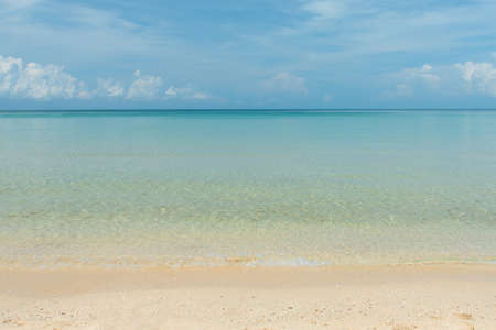 aqua sea water surface waves on white sandy beaches and clouds, natural blue sky. summer vacations...