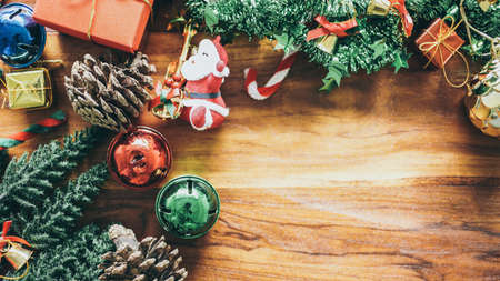 Christmas composition copy space for your text. Gift box, ball, bell shiny and Christmas tree Miniature on wood flat lay, top view vintage filterの写真素材