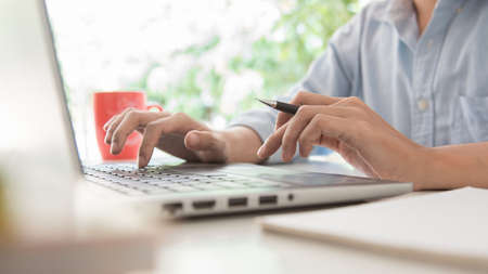 newsletter concept Hand of businessman checking message box on digital laptop Vintage tone...