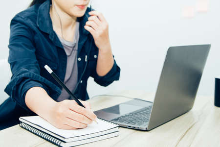 woman in earphones speak with the customer working talk consult client online using network on...
