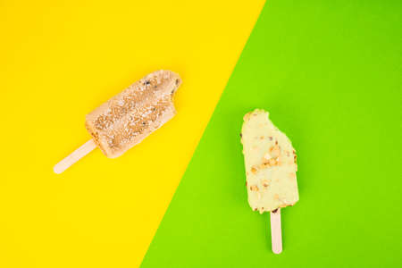 ice cream stick on yellow and green backgroundの写真素材